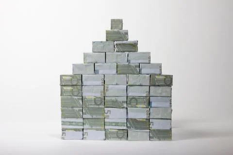 Five Euro banknotes folded into rectangular boxes and stacked into a pyramid 스톡 사진