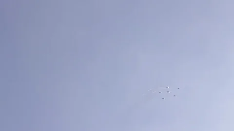 Five fighter jets in the blue sky. A general plan. Aerobatic figures. Airshow Stock Footage 124146472