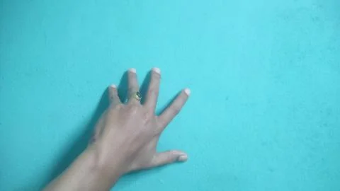 Five fingers on the wall on a blue background Stock Photos