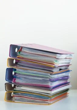 Five folders with documents stacked in a pile on the table Foto stock