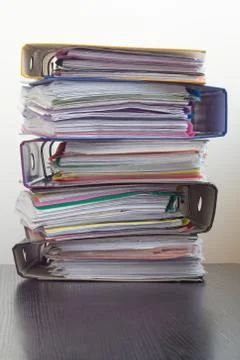 Five folders with documents stacked in a pile on the table Foto stock
