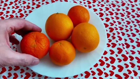 Five Fresh Oranges on White Plate Over Heart - Patterned Tablecloth 스톡 동영상 327520098