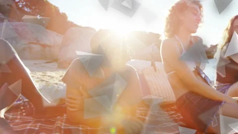 Five friends chatting on striped mat, sun flaring causing triangles obscuring Stock Footage 333790191