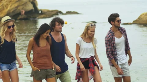 Five friends walking on beach Stock Footage 68798774