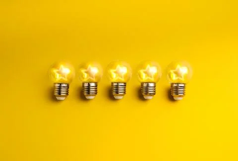 Five glowing clear light bulbs with stars neon lamp shape inside, isolated .. Stock Photos