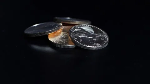 Five gold dollar coins with a value of 10000 dollars lie on a turntable1 Video stock 137053708