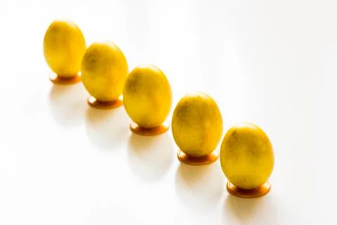 Five gold easter eggs on the table Stock Photos