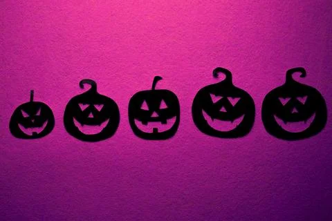 Five hand-painted black pumpkins on a pink background Stock Photos