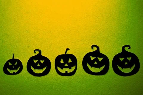 Five hand-painted black pumpkins on a green background Stock Photos