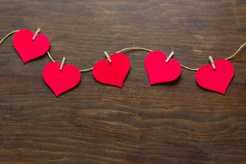 Five hearts attached to a rustic thread Stock Photos