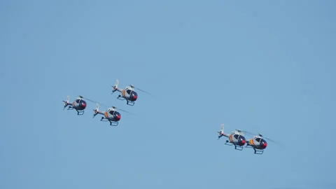 Five helicopters in staggered diagonal formation against blue sky Stock-Footage 336455834