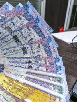 Five hundreds notes in a raw in treasury office and laptop in background Stock Photos