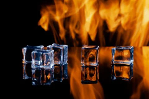 Five ice cubes on a black background, in the background flames Stock Photos