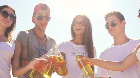 Five joyful handsome friends drinks sider at beach Stock-Footage 67349131