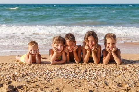 Five kids on the beach Stock Photos