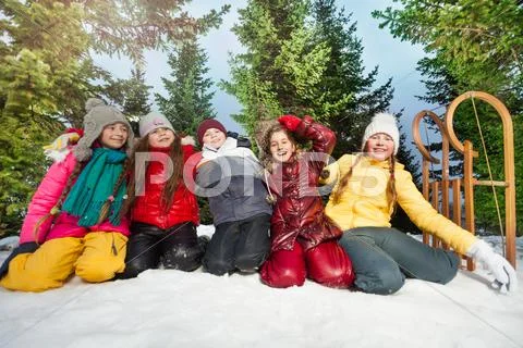 Five Kids Playing In The Snow At Wintertime