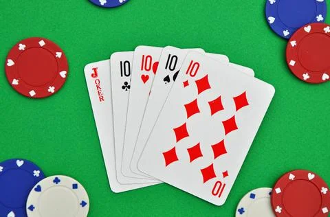Five of a Kind. Poker hand. Playing cards. Green baize. Casino gambling chips Stock Photos