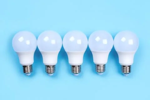 Five LED bulbs on blue background. Saving energy concept. Foto stock