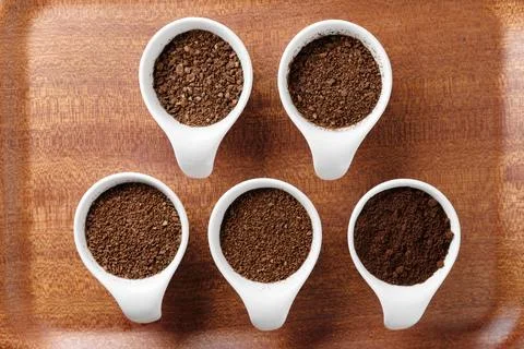 Five levels of ground coffee beans. Stock Photos