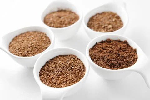 Five levels of ground coffee beans. Stock Photos