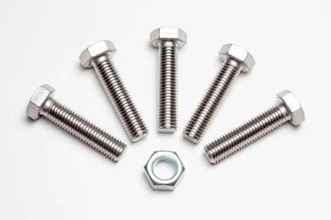 Five lying bolts and an nut Stock Photos