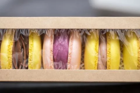 Five macaroons in paper packaging on the table. packaging process. home bak.. Stock Photos