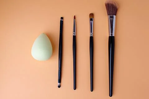 Five makeup brushes lie parallel, brushes for eyeliner, eyeshadow, lipstick. Stock Photos