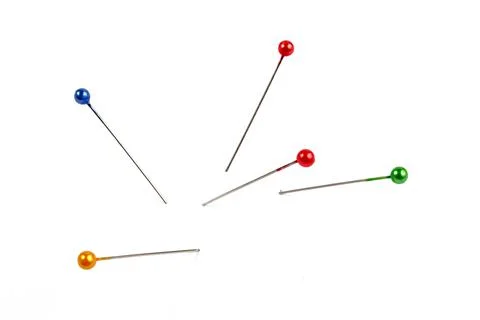 Five multi-colored pins on a white background, isolate. Foto stock