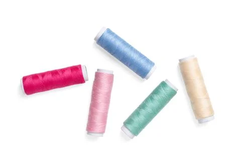 Five multi colored polyester sewing thread spools, from above, photo Stock Photos