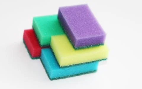 Five multi-colored sponges for cleaning the apartment and washing dishes. Stock Photos