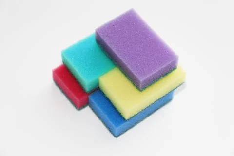 Five multi-colored sponges for cleaning the apartment and washing dishes. Stock Photos
