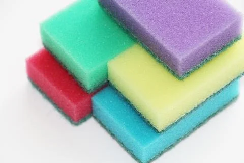 Five multi-colored sponges for cleaning the apartment and washing dishes. Stock Photos