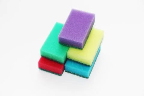 Five multi-colored sponges for cleaning the apartment and washing dishes. Stock Photos