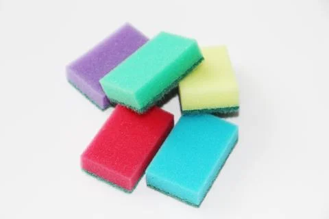 Five multi-colored sponges for cleaning the apartment and washing dishes. Stock Photos