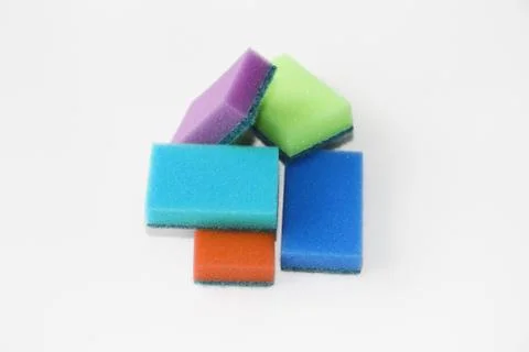 Five multi-colored sponges for cleaning the apartment and washing dishes. Stock Photos