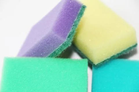 Five multi-colored sponges for cleaning the apartment and washing dishes. Stock Photos