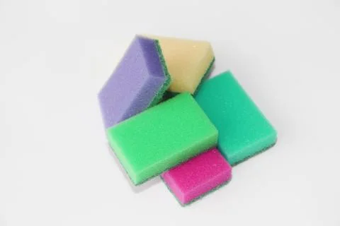 Five multi-colored sponges for cleaning the apartment and washing dishes. Stock Photos