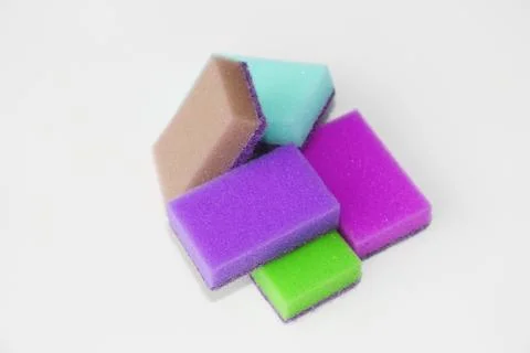 Five multi-colored sponges for cleaning the apartment and washing dishes. Stock Photos