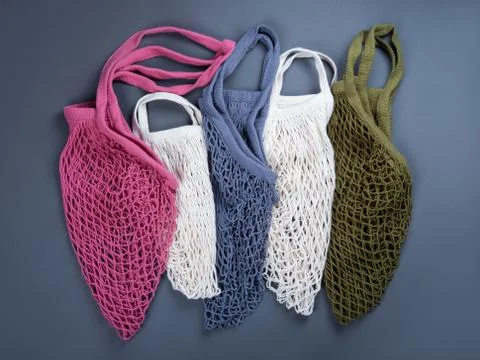 Five multicolor reusable string bags for different products. Stock Photos