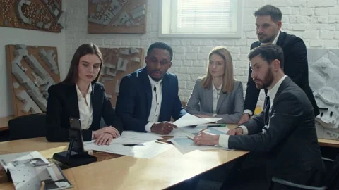Five multicultural colleagues looking at smartphone screen, waiting for video Stock Footage 189032139