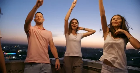 Five multiethnic friends having a summer rooftop party, dancing with sparklers Stock-Footage 94720120