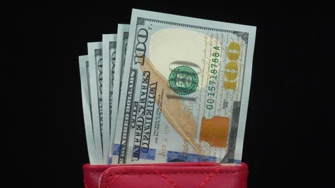 Five new 100 dollar bills in a red leather wallet Stock Footage 346081750