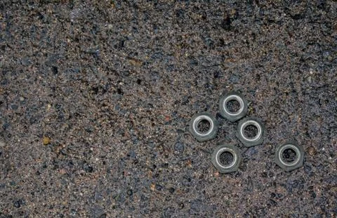 Five nuts. Wet asphalt Stock Photos