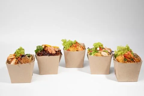 Five open eco-friendly brown paper boxes filled with various delicious and .. Stock Photos