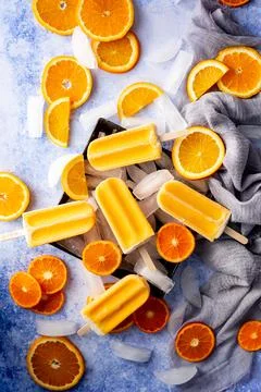 Five orange popsicles on ice Stock Photos