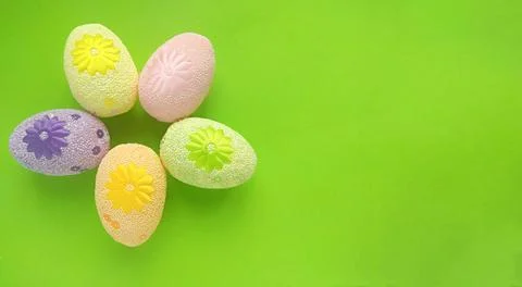 Five painted Easter eggs on a green background 스톡 사진