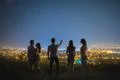 The five people stand on the background of the city lights. night time Photo
