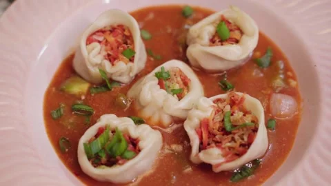 Five pieces of devil momos with gravy in a ceramic plate. Stock Footage 282766798