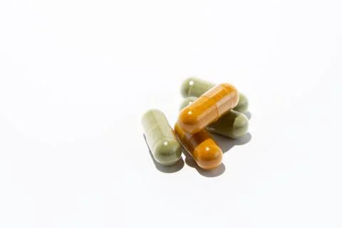Five pills (gel capsules with moringa and curcuma) Stock Photos