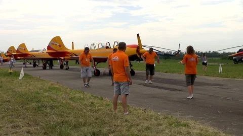 Five pilots from aerobatic team First flight work out aerobatics on ground. Stock Footage 121136148